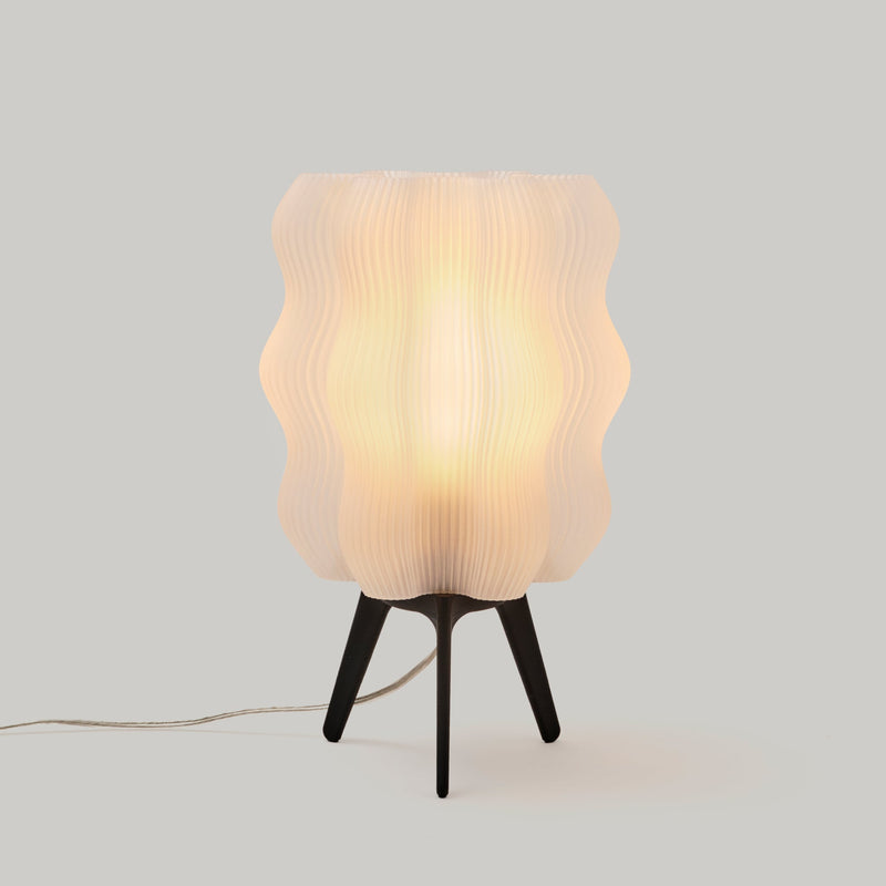 Matte black Wavy Lamp on a neutral background
