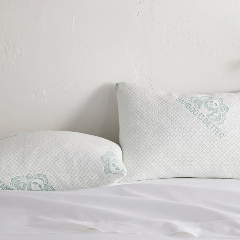 Adjustable bamboo cooling pillows on a white bed