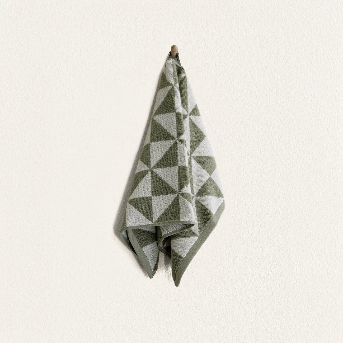 Umbra towel draped over rack in styled minimalist bathroom interior