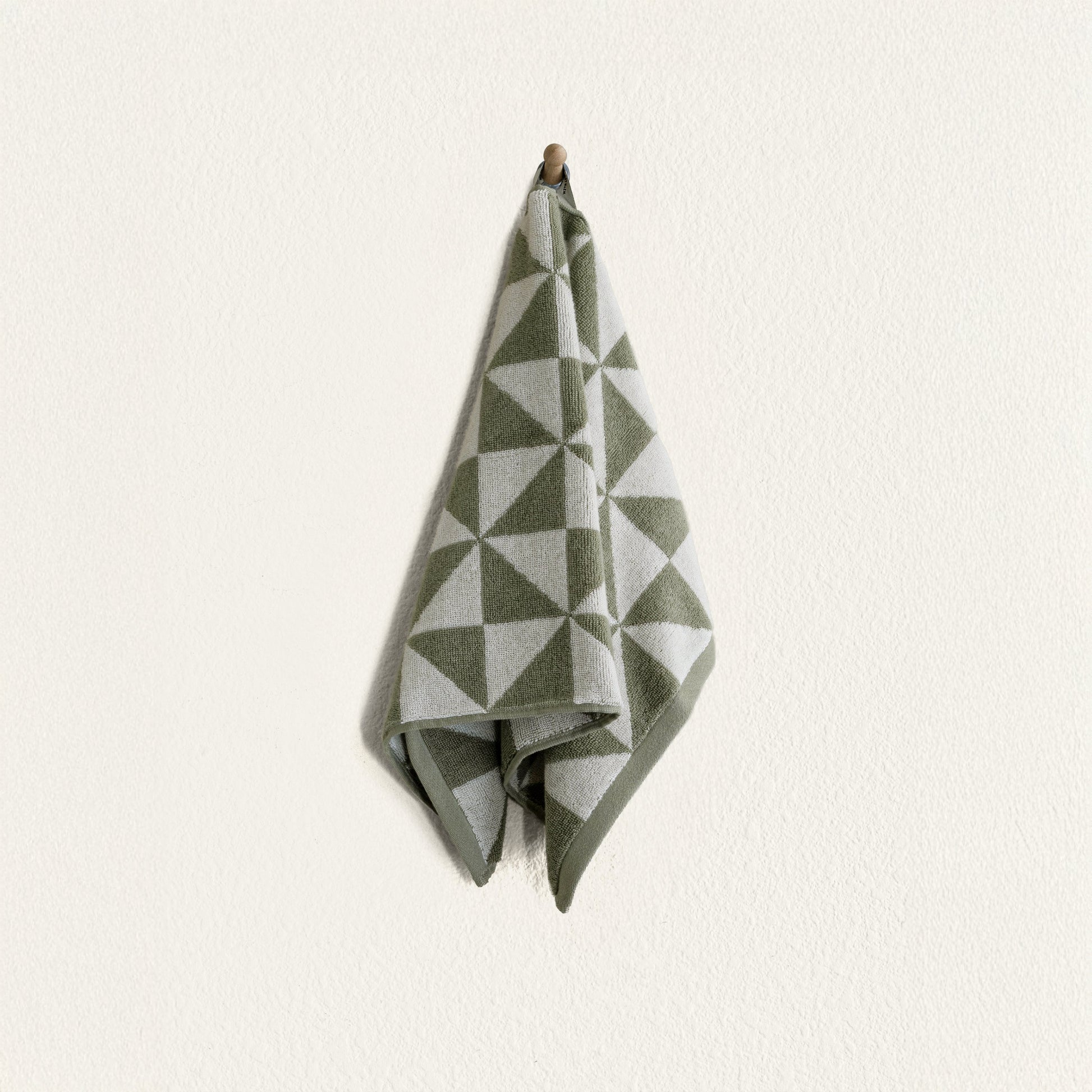 Umbra towel draped over rack in styled minimalist bathroom interior