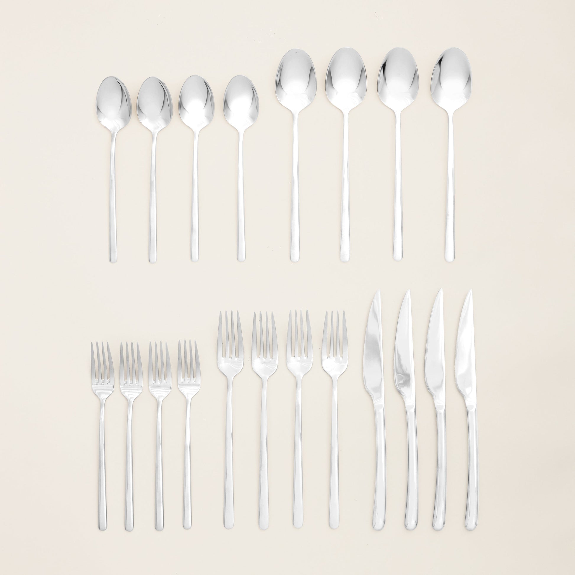 Single Emilia mirror polish teaspoon on plain studio background