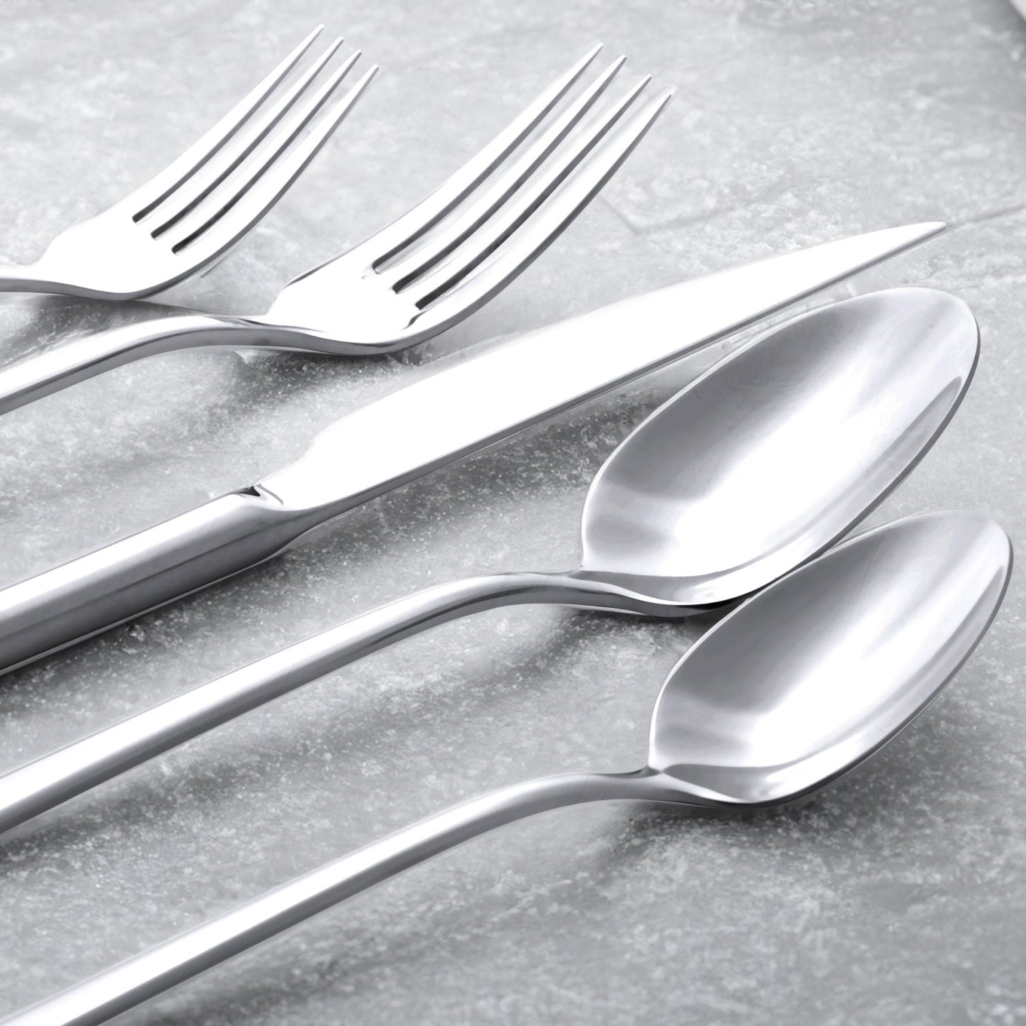 Single Emilia mirror polish salad fork on plain studio background