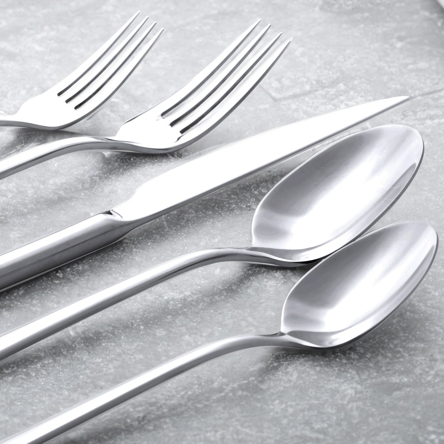 Single Emilia mirror polish salad fork on plain studio background