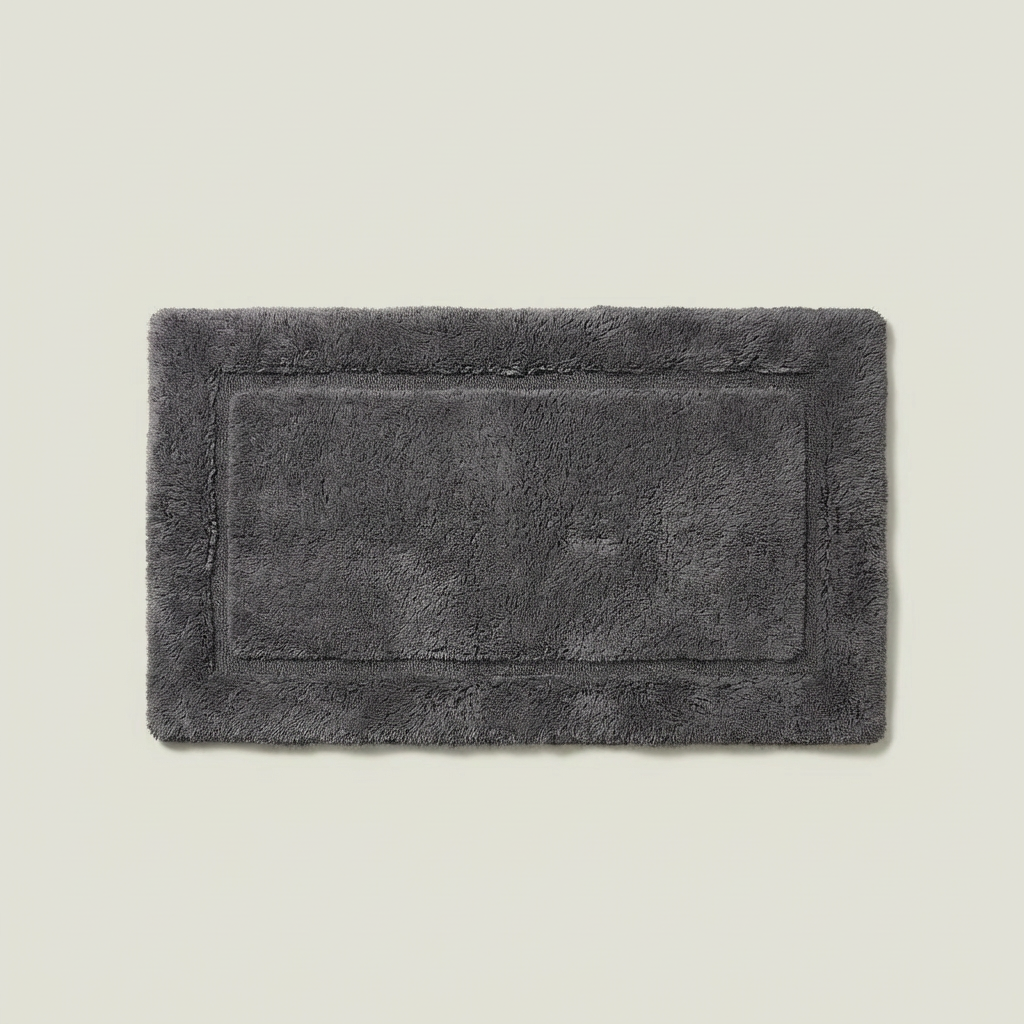 Bath mat in sand tan color photographed flat on plain background