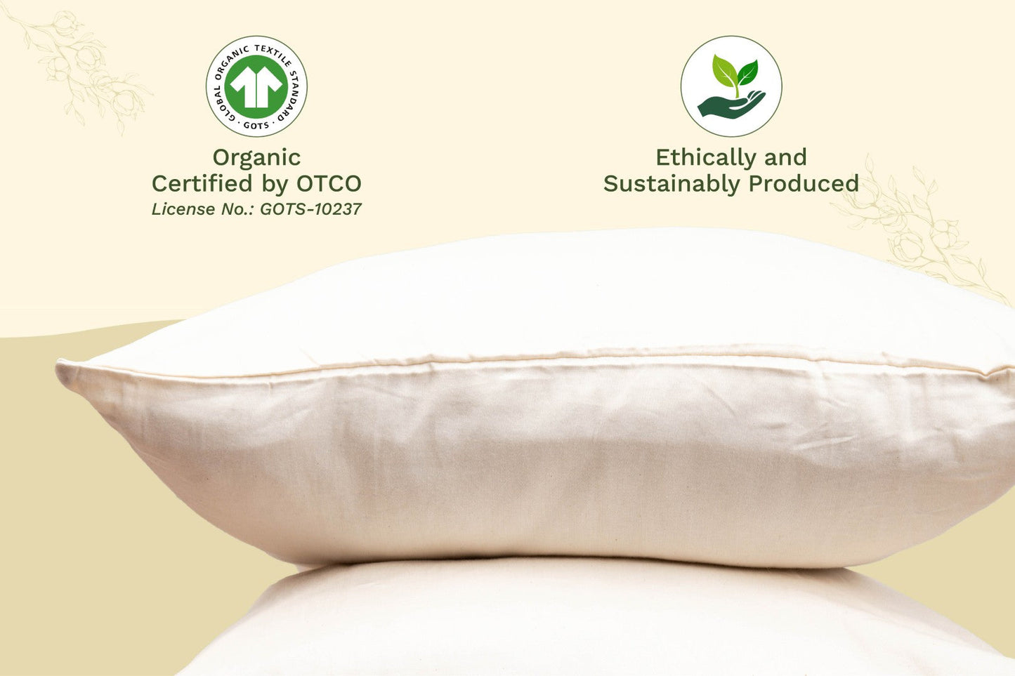 Organic sateen pillowcases in ivory cream displayed beside matching folded sheets