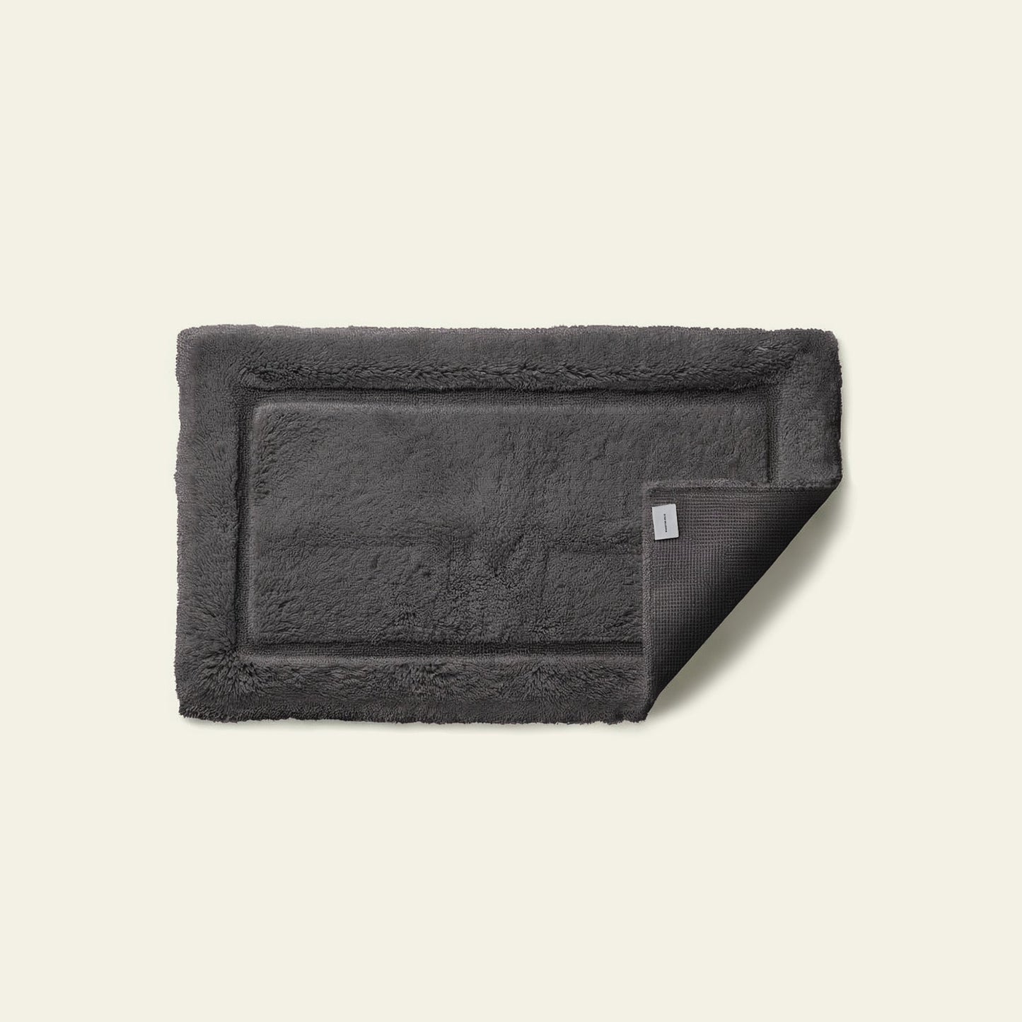Bath mat styled at sink showing comfortable absorbent cotton surface