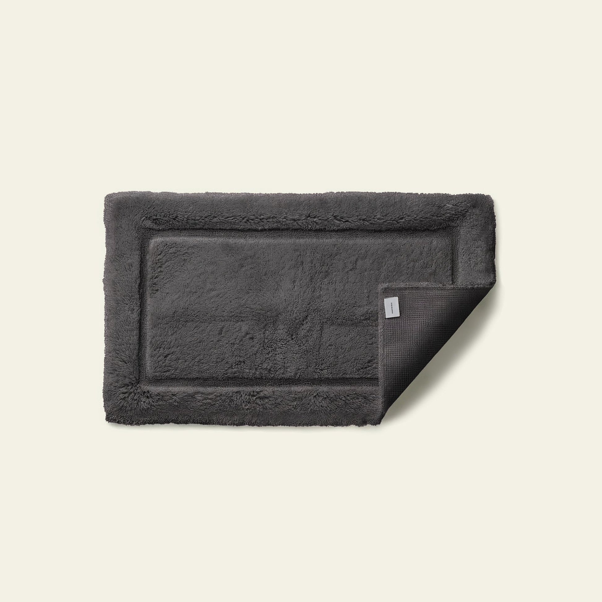 Bath mat styled at sink showing comfortable absorbent cotton surface