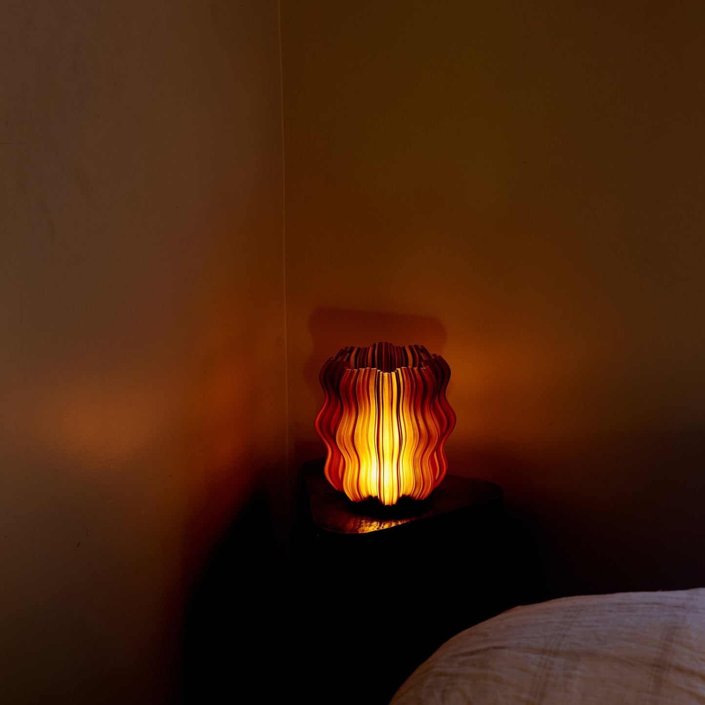 Mini Wavy Lamp glowing on bedside table in cozy bedroom setting