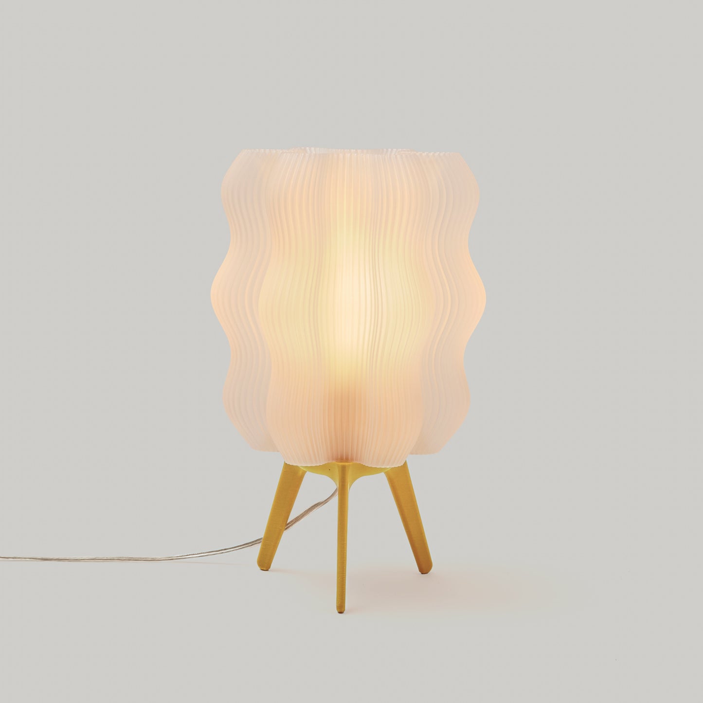 Yellow Wavy Lamp shown on plain studio background highlighting bright color