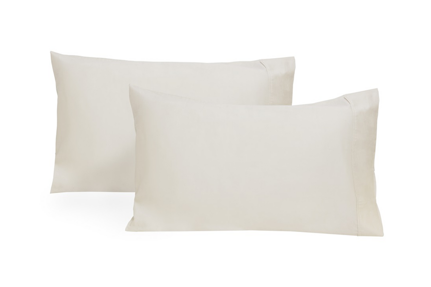 Organic sateen pillowcases in navy blue draped softly over linen bedspread