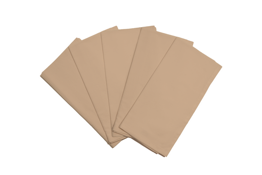 Stack of white flour sack kitchen towels folded neatly on a wooden countertop