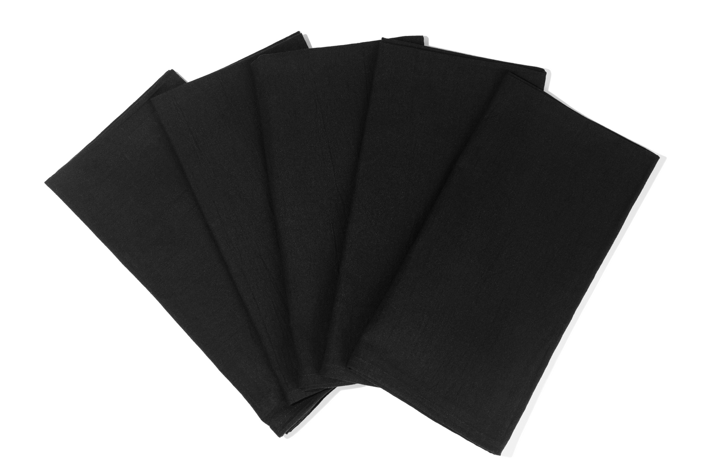 Flour sack kitchen towels hanging from oven handle in a bright kitchen