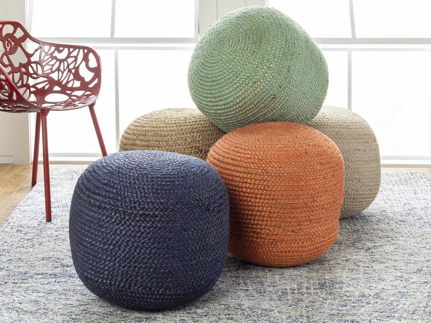 Kaumakani jute pouf at side of armchair styled with throw blanket
