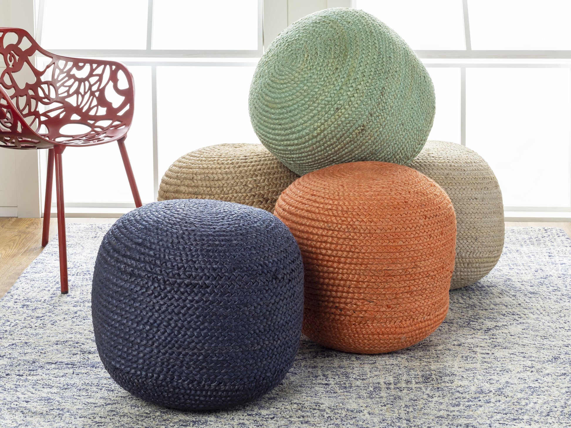 Kaumakani jute pouf at side of armchair styled with throw blanket