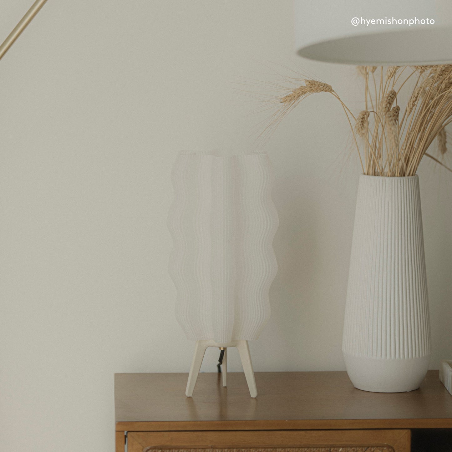 Customer photo of Wavy Lamp styled on entryway table with plant
