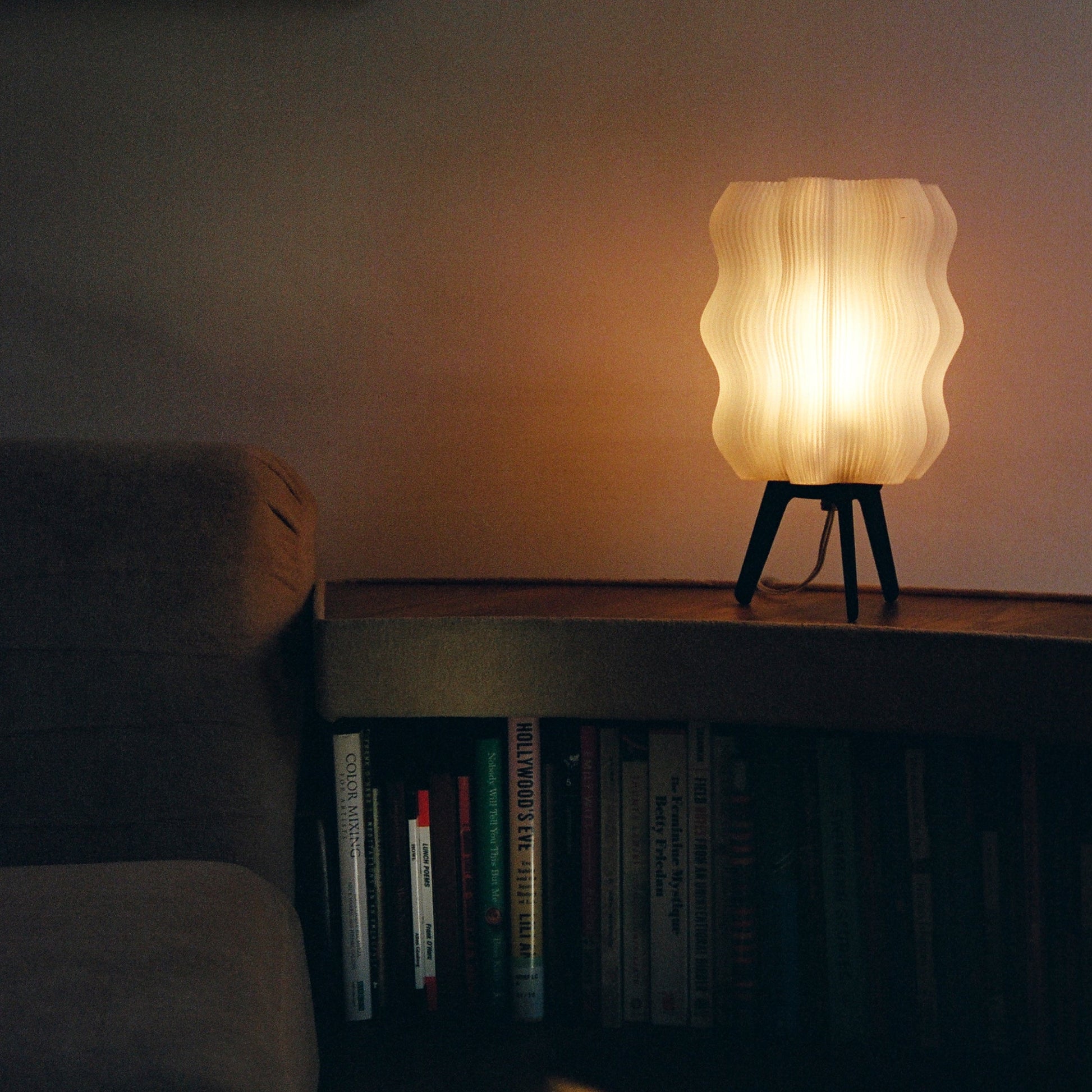 Wavy Lamp glowing on side table in styled living room setting