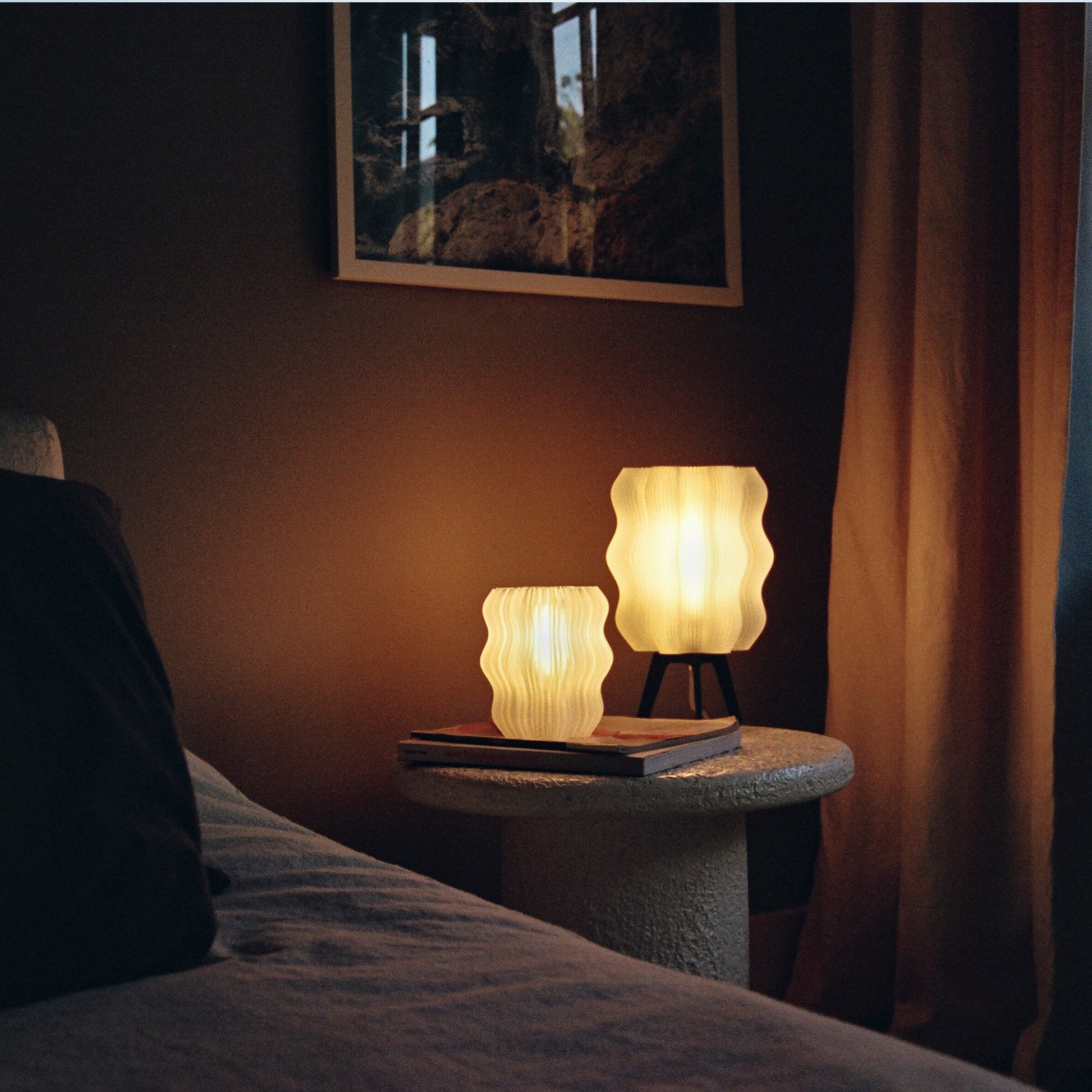 Wavy Lamp on shelf next to books in warm interior