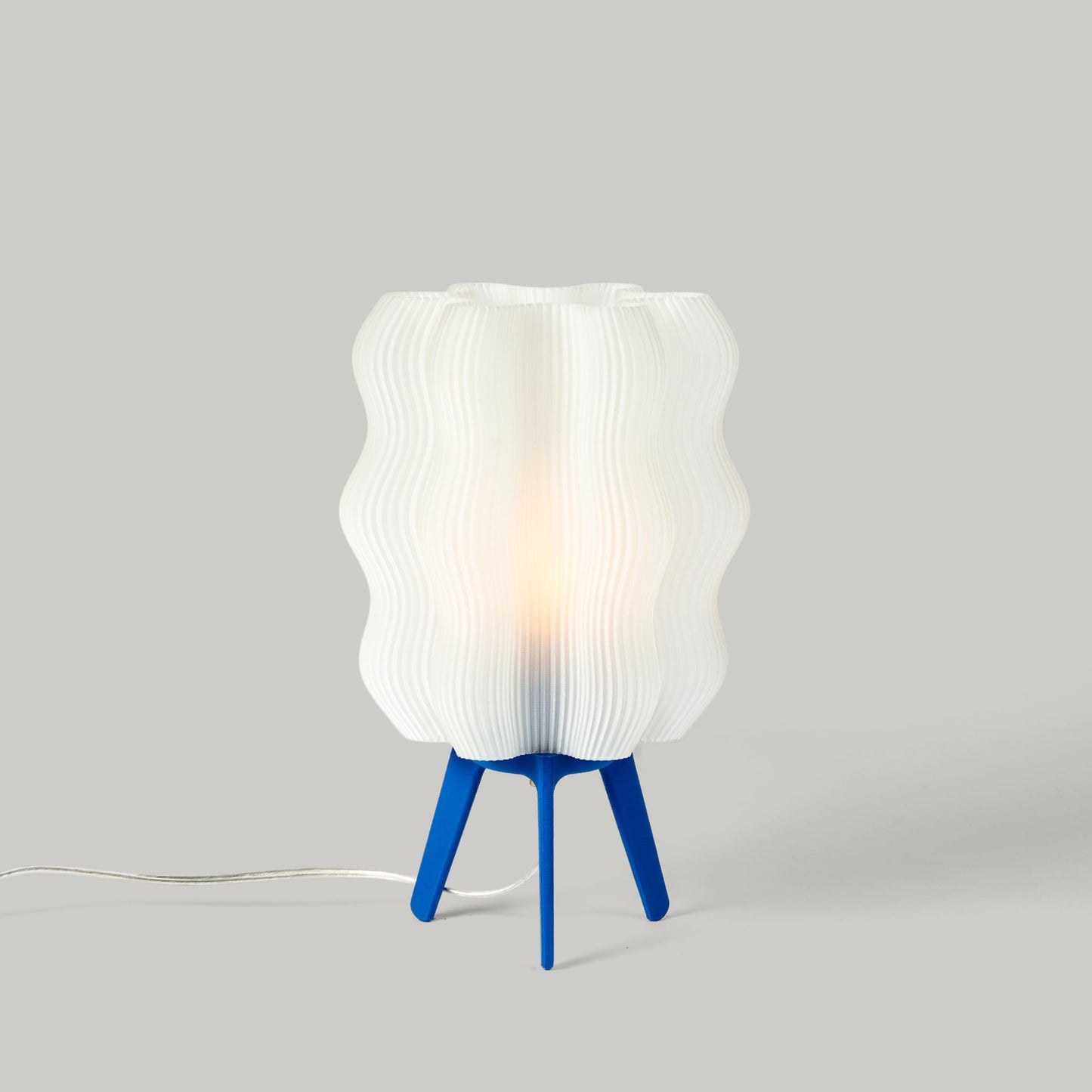 Cobalt blue standard Wavy Lamp shown on plain studio background