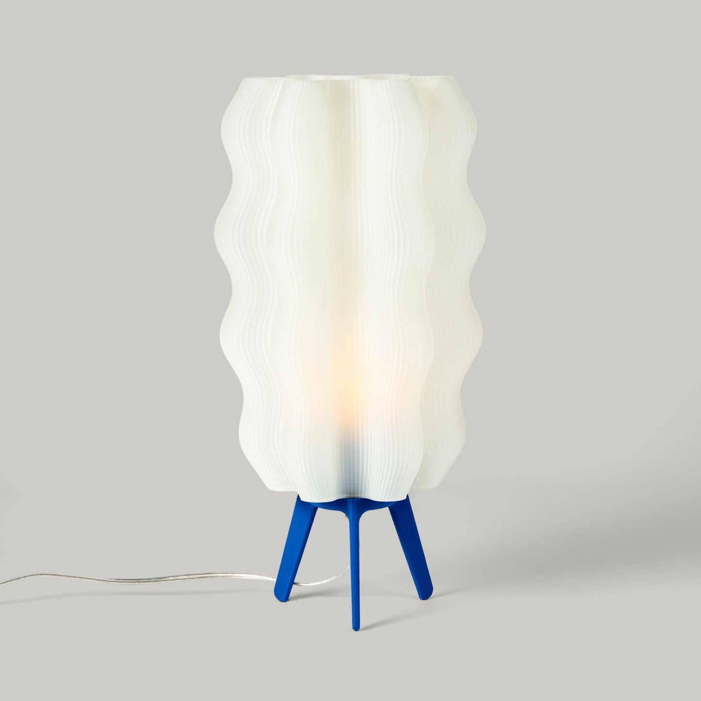 Cobalt blue tall Wavy Lamp on plain studio background showing form