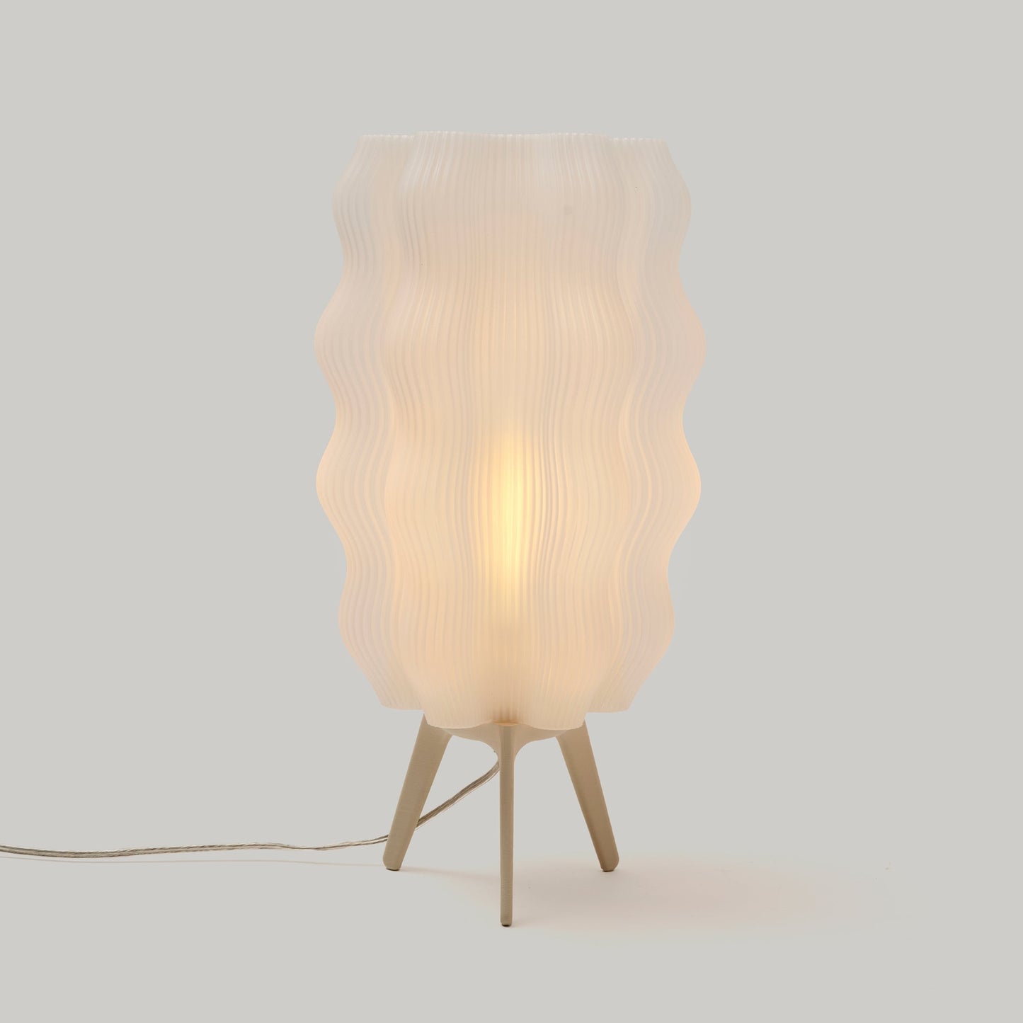Eggshell color tall Wavy Lamp on plain studio background