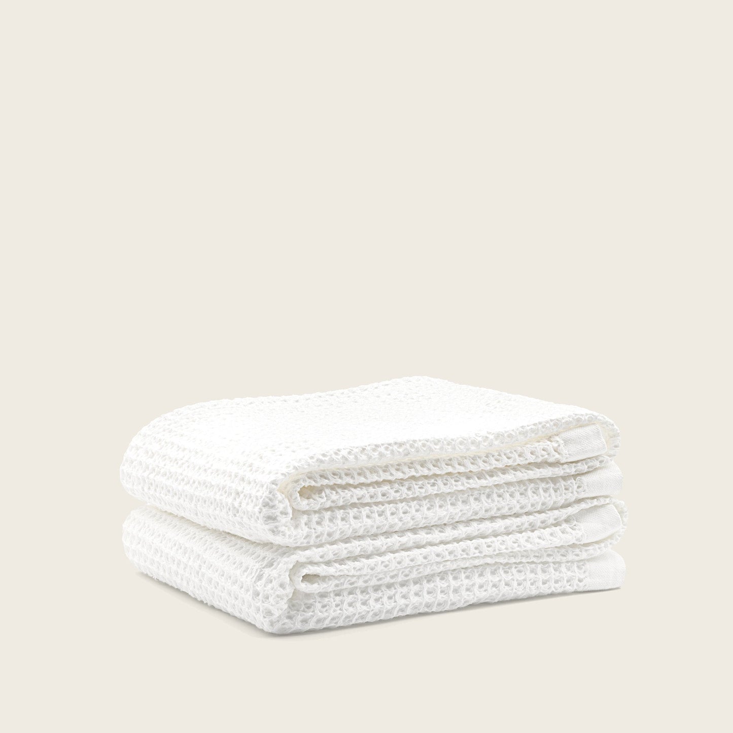 Closeup hand touching Sedona waffle towel demonstrating texture and softness