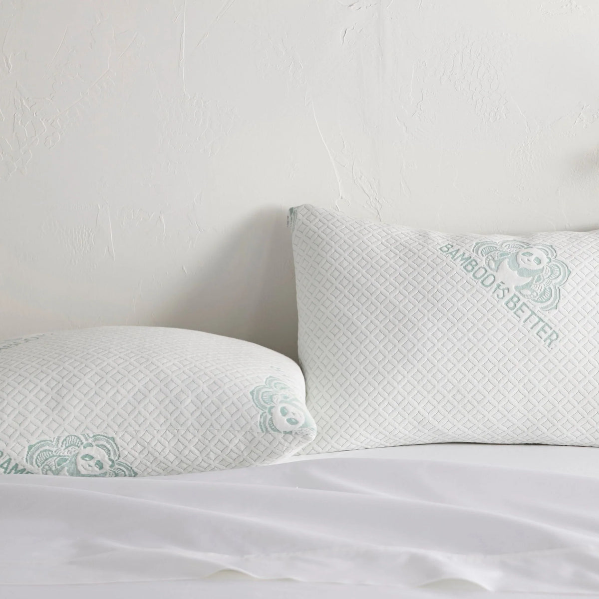 Pair of bamboo cooling pillows on a white bed