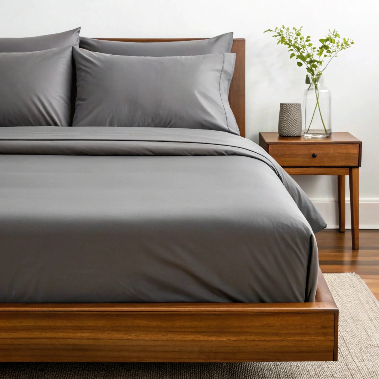 Bamboo sheet set in sage green folded with corresponding pillowcases on top