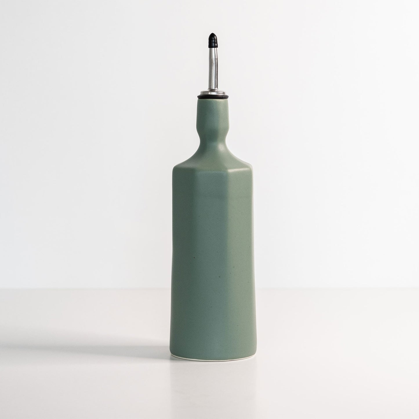 Closeup detail of Elixir dispenser handmade glaze finish on porcelain surface