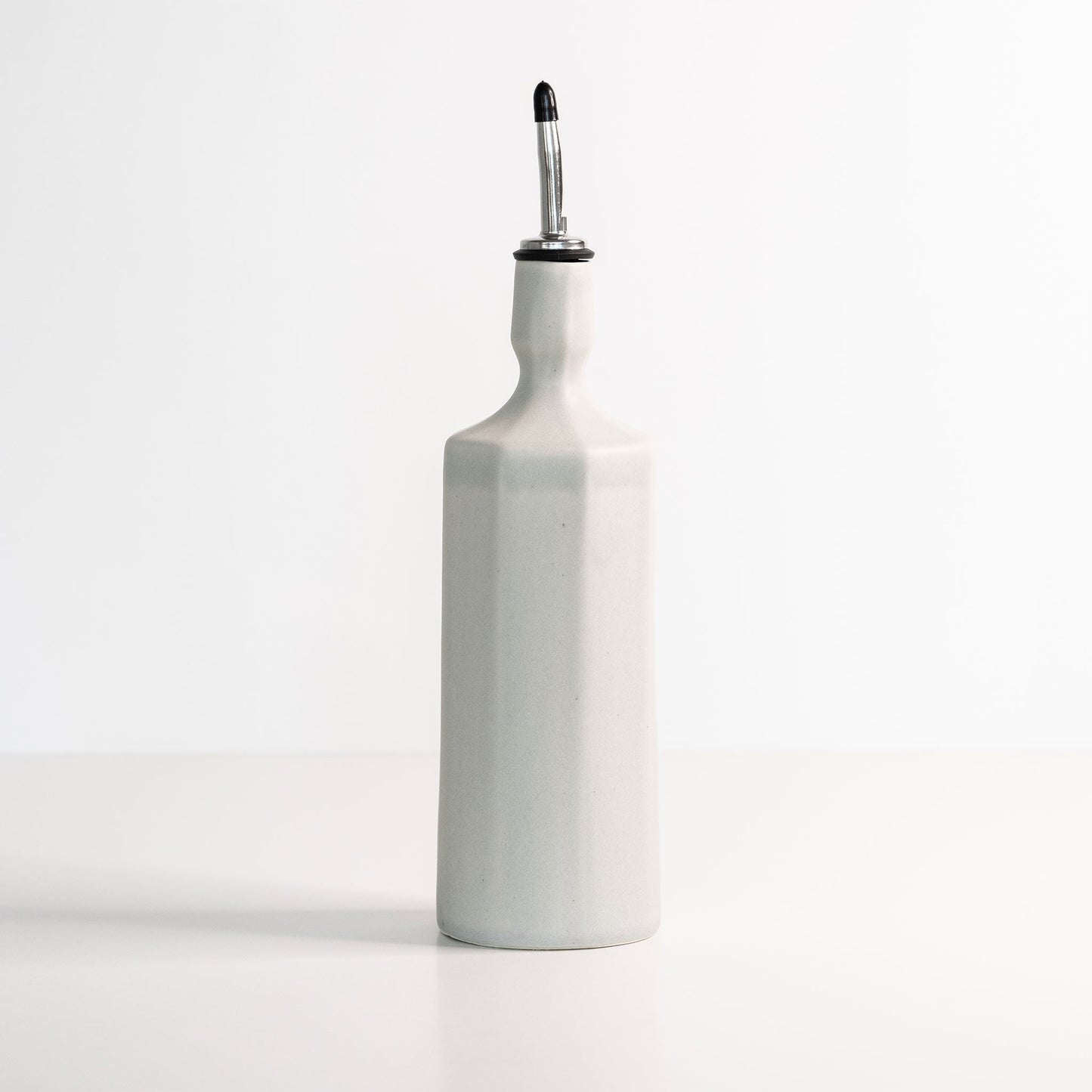 Elixir dispenser top view showing handmade porcelain stopper detail