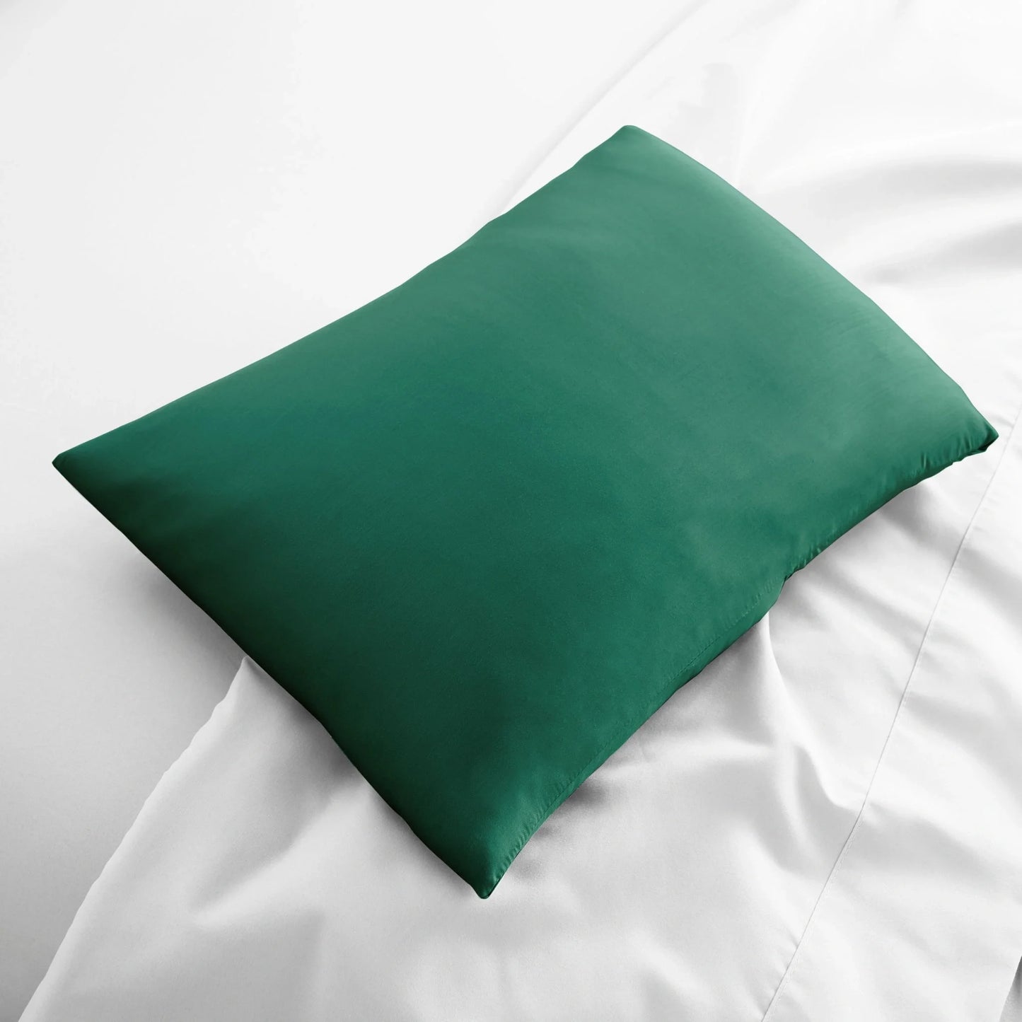 Travel size bamboo pillowcase shown rolled inside small travel bag