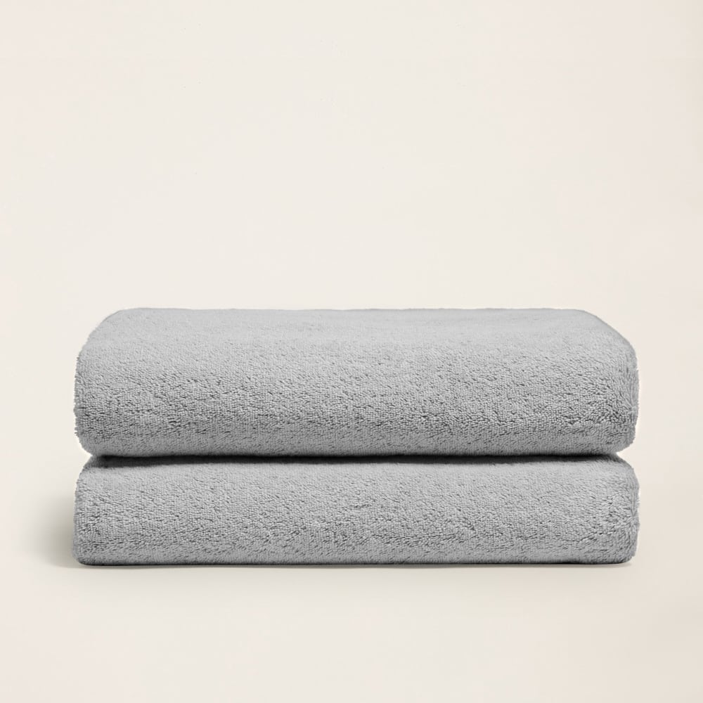 Ultraplush towel folded showing softness with hand grazing surface