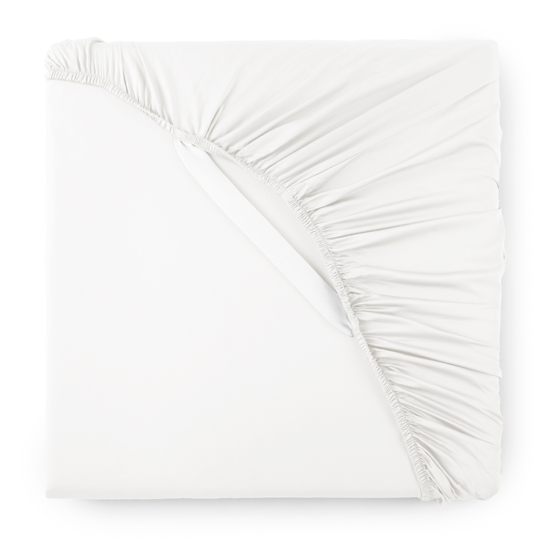 Bamboo fitted sheet styled on dressed bed with neutral linens