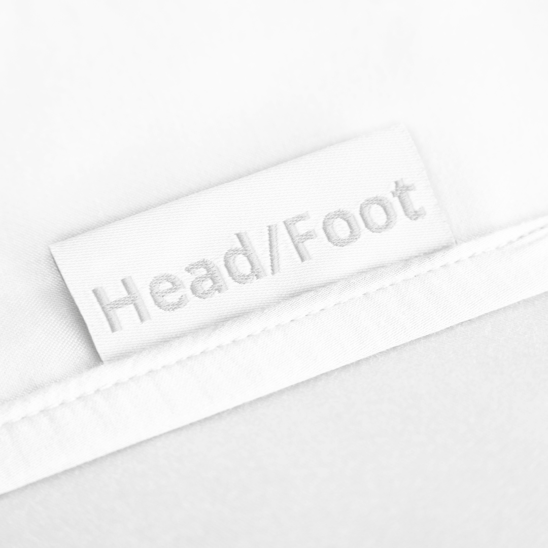 Bamboo fitted sheet corner detail showing elastic edge and stitching