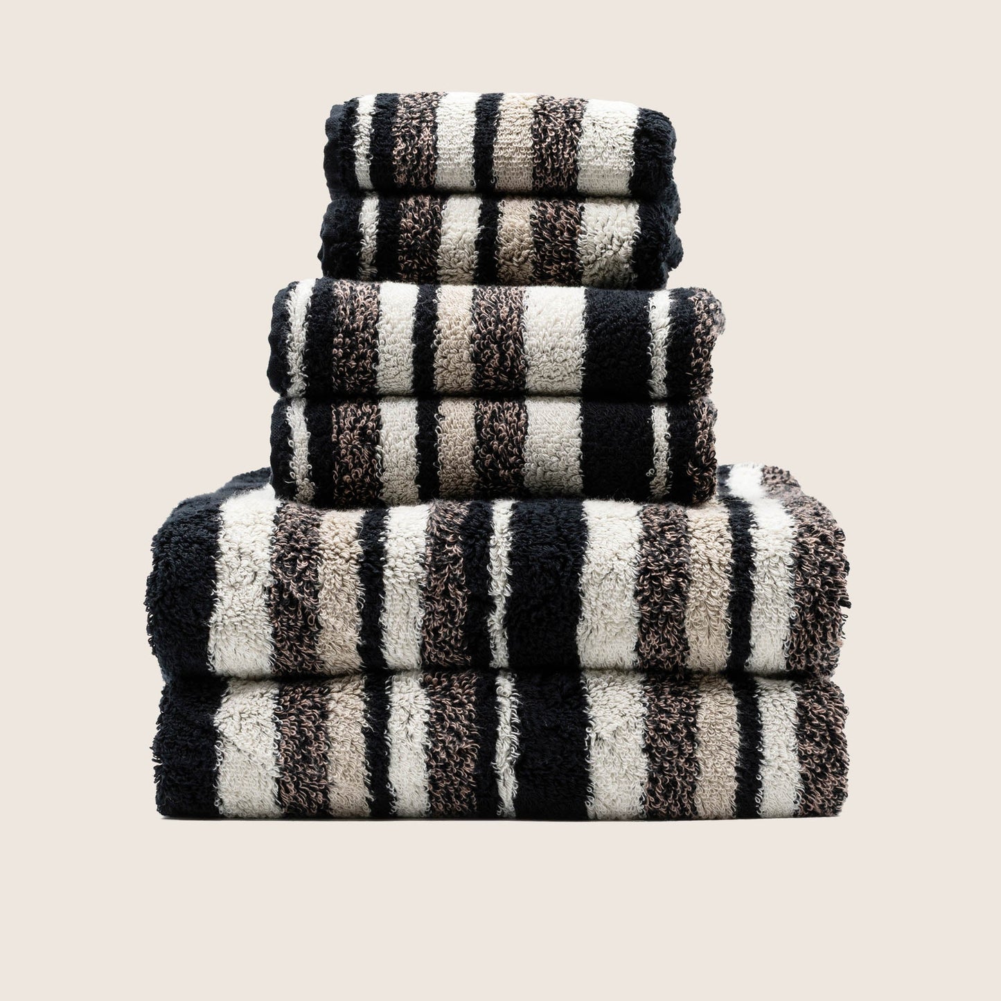 Italic Ultraplush towel rolled and styled on bathroom shelf with accents