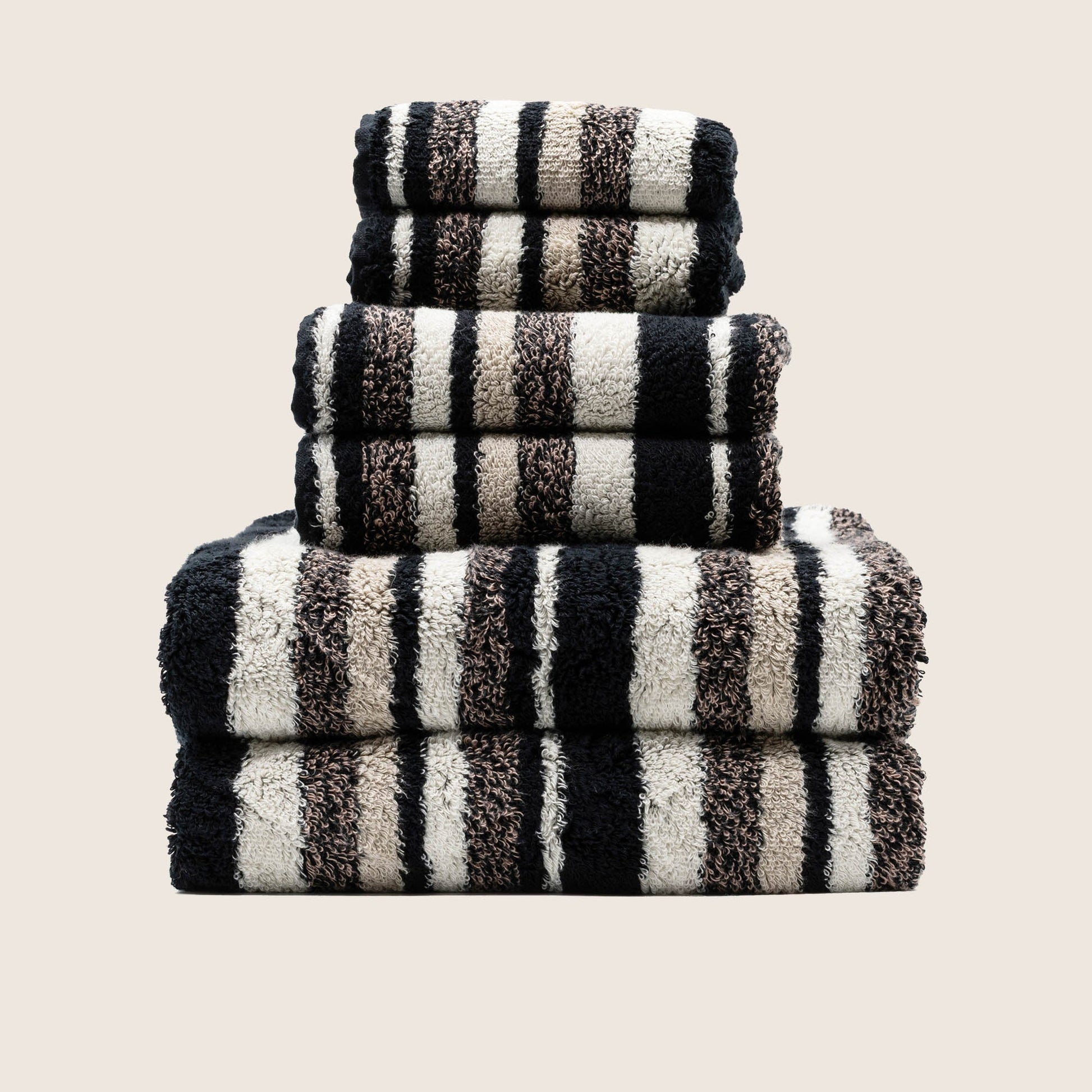 Italic Ultraplush towel rolled and styled on bathroom shelf with accents