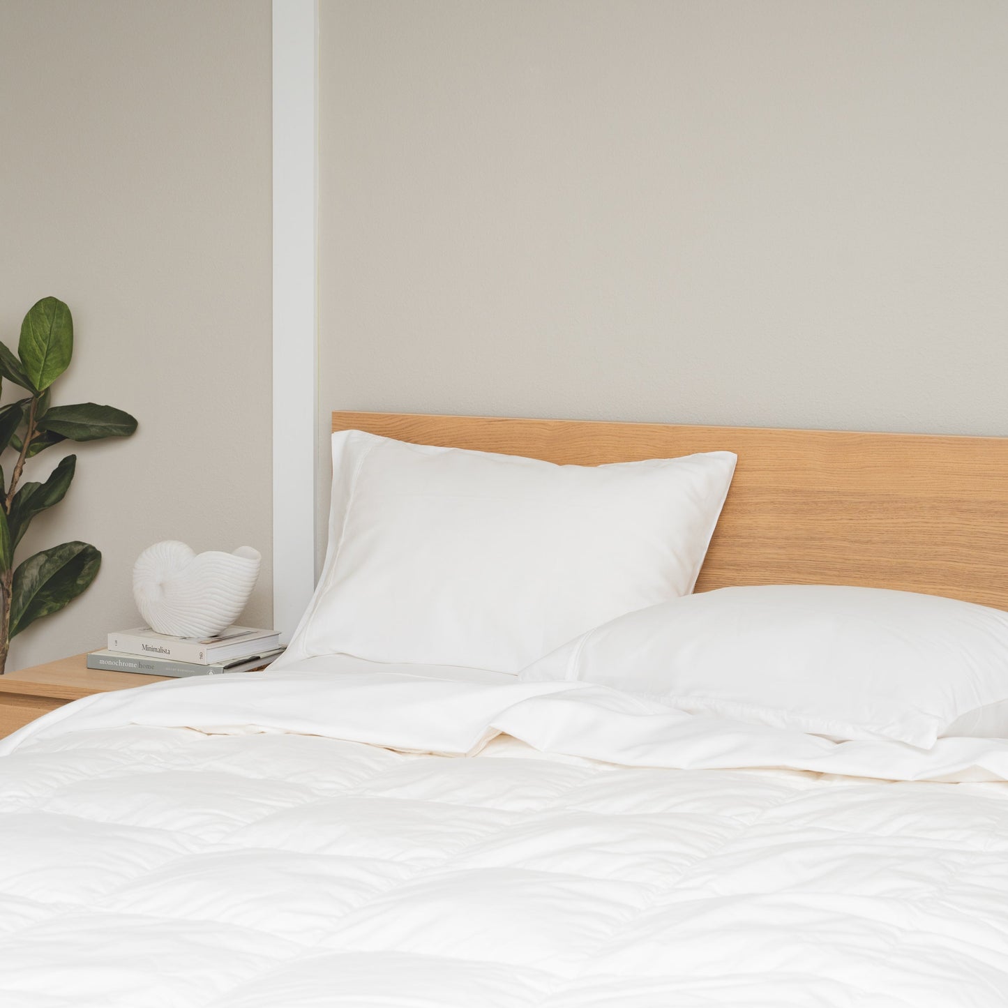 Folded organic sateen sheet set showing silky lustrous finish and crisp folded edges